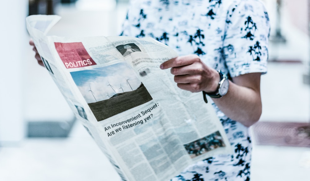 freelancer reads political section of newspaper